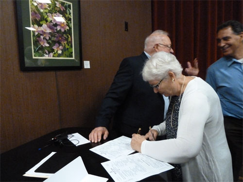 Photo of Bob's sister Alyce Houskamp signing as witness for groom
