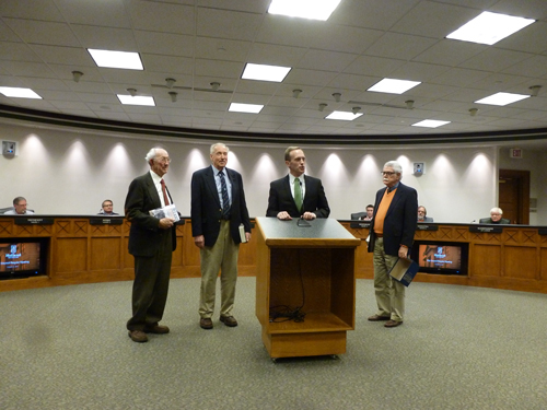 Photo of Robert Swierenga presenting the book to the Holland City Council